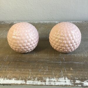 Two pink ceramic orbs with hobnail pattern
